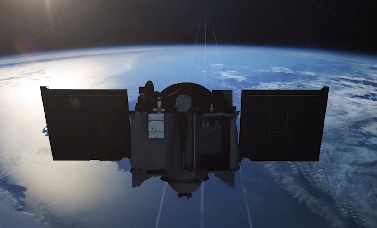 A spacecraft with deployed solar arrays in orbit above Earth